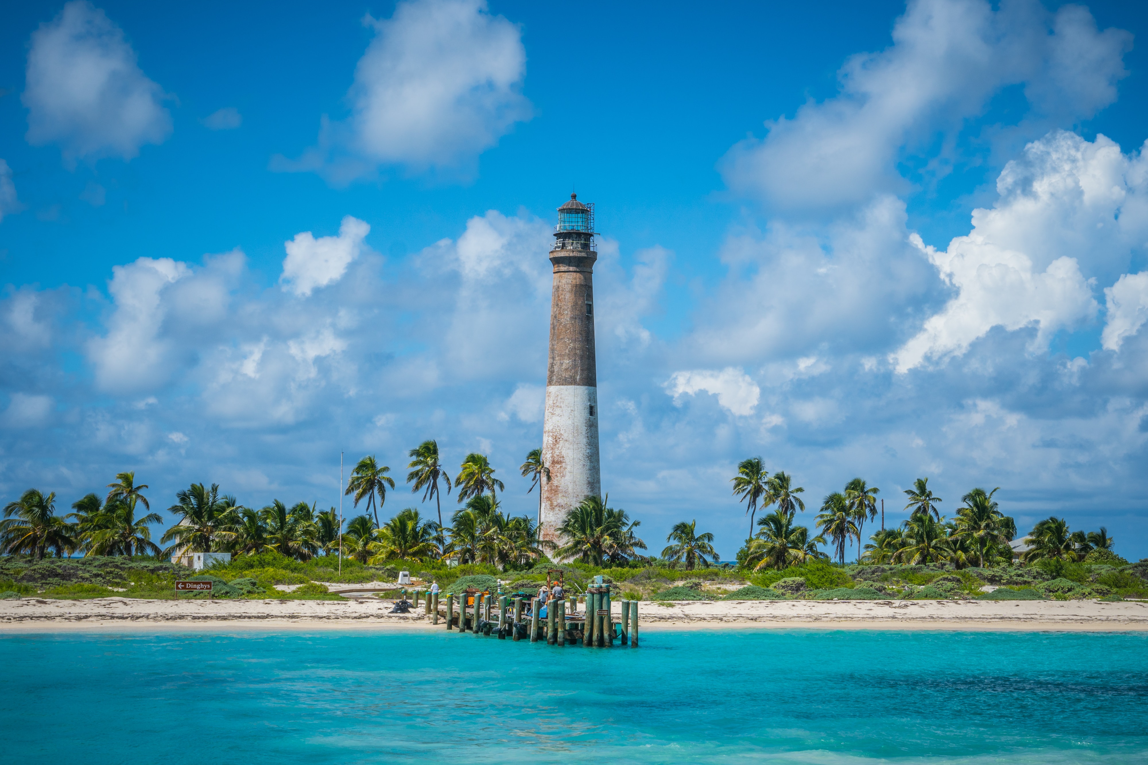 a big lighthouse on the side of a beach